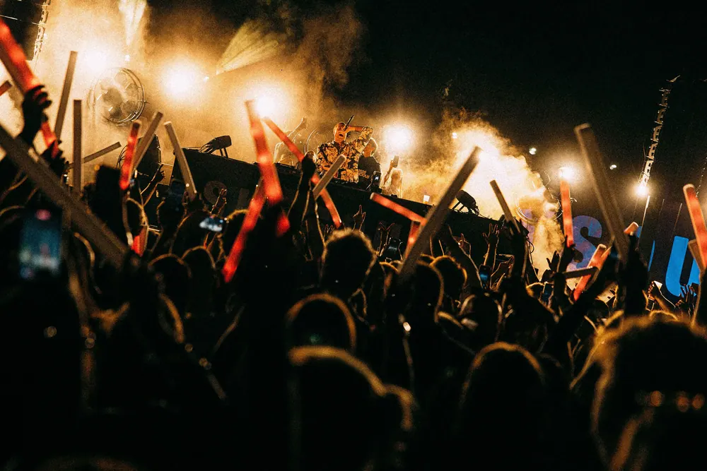 Crowd in front of the SkySound main stage with flames
